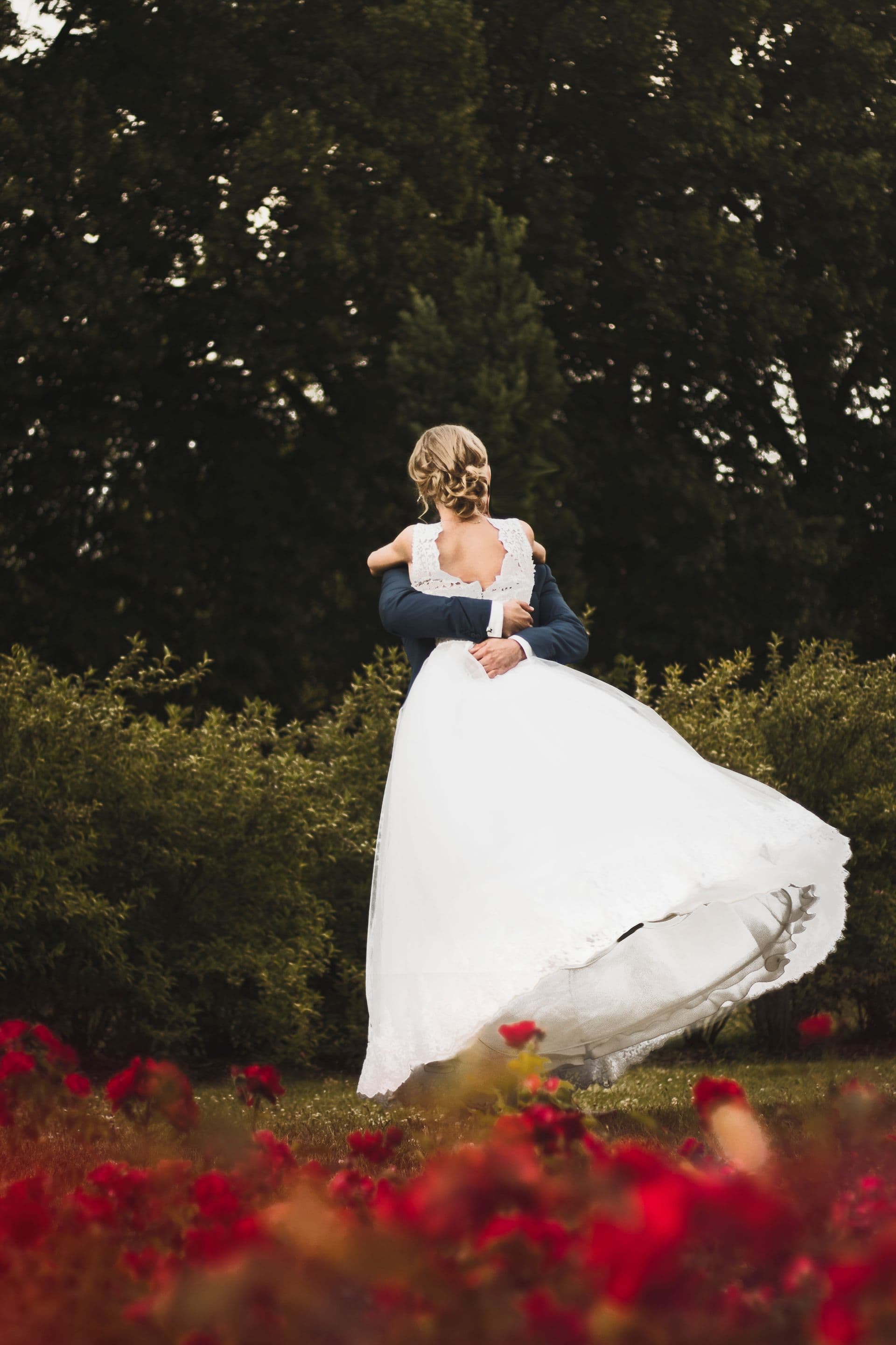 Bride laughing and twirling on a lawn