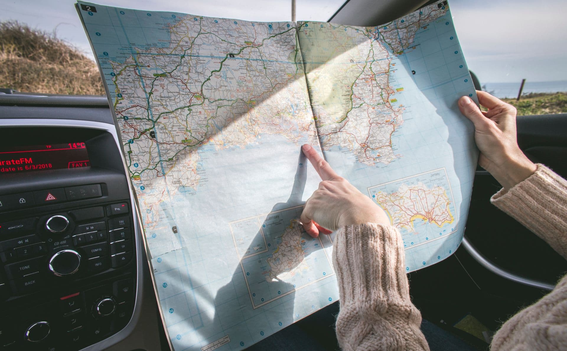 Hands tracing a route on a paper map