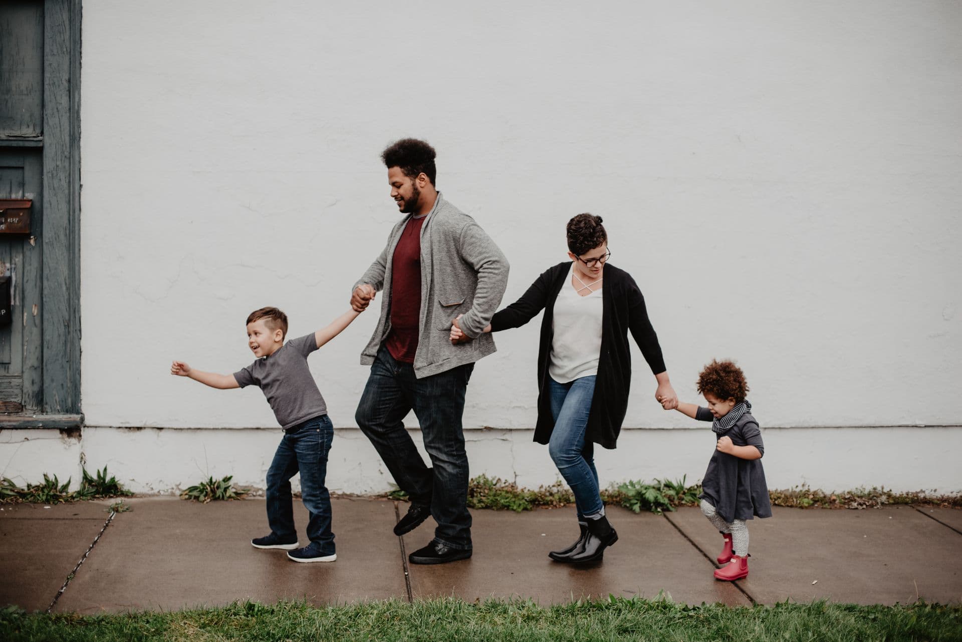 Family walking hand in hand outdoors