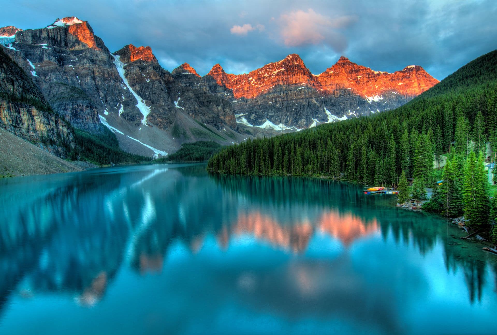 Alpine lake at sunrise with glowing peaks