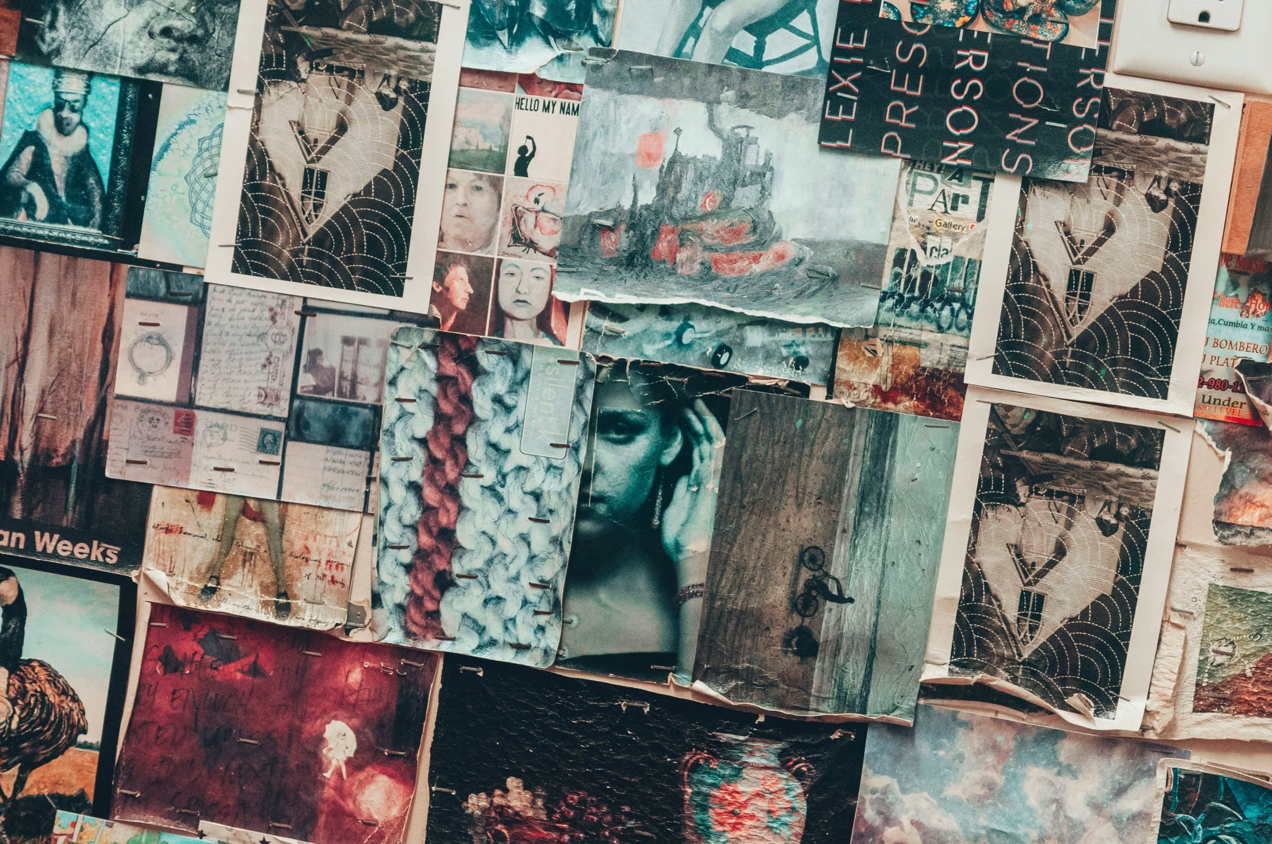 Dense wall of overlapping vintage prints, postcards and artwork